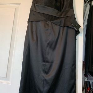 Black strapless tiered dress with tulle detail.
